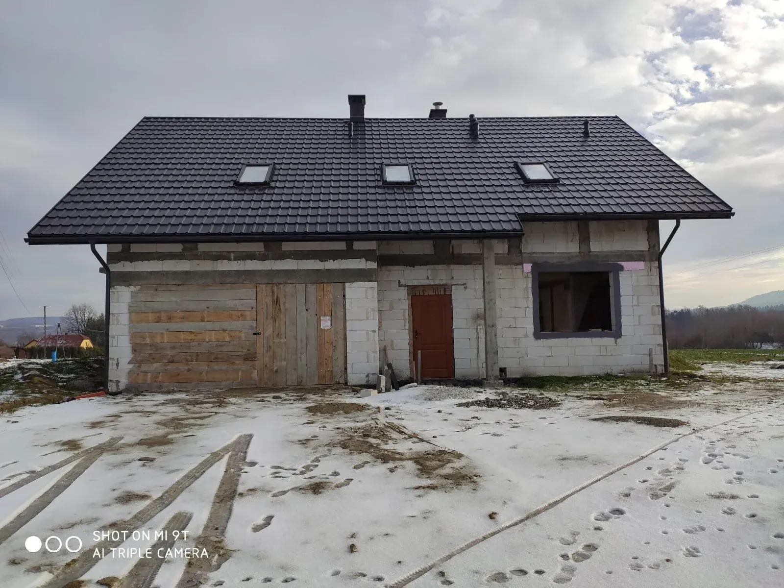Dom w stanie surowym zamkniętym z gotowym dachem zimą